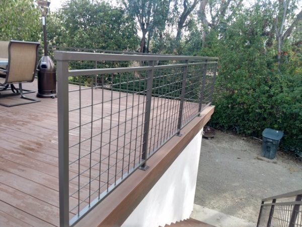 Metal railing along a coated deck